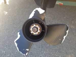 Damaged outboard propeller with chipped blades requiring repair or replacement at Anchor Marine in Menomonie Wisconsin.